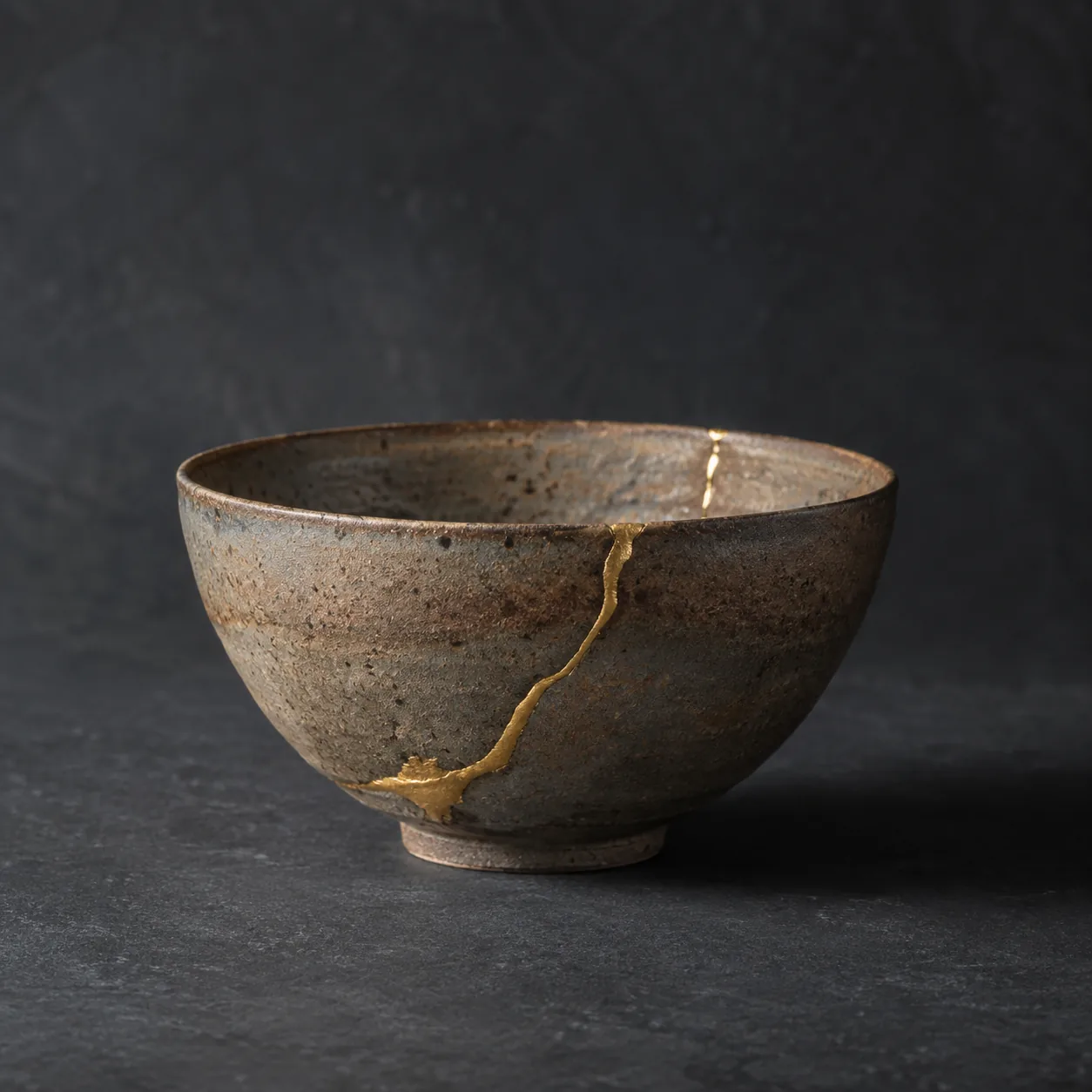 A clay bowl with a crack repaired in gold