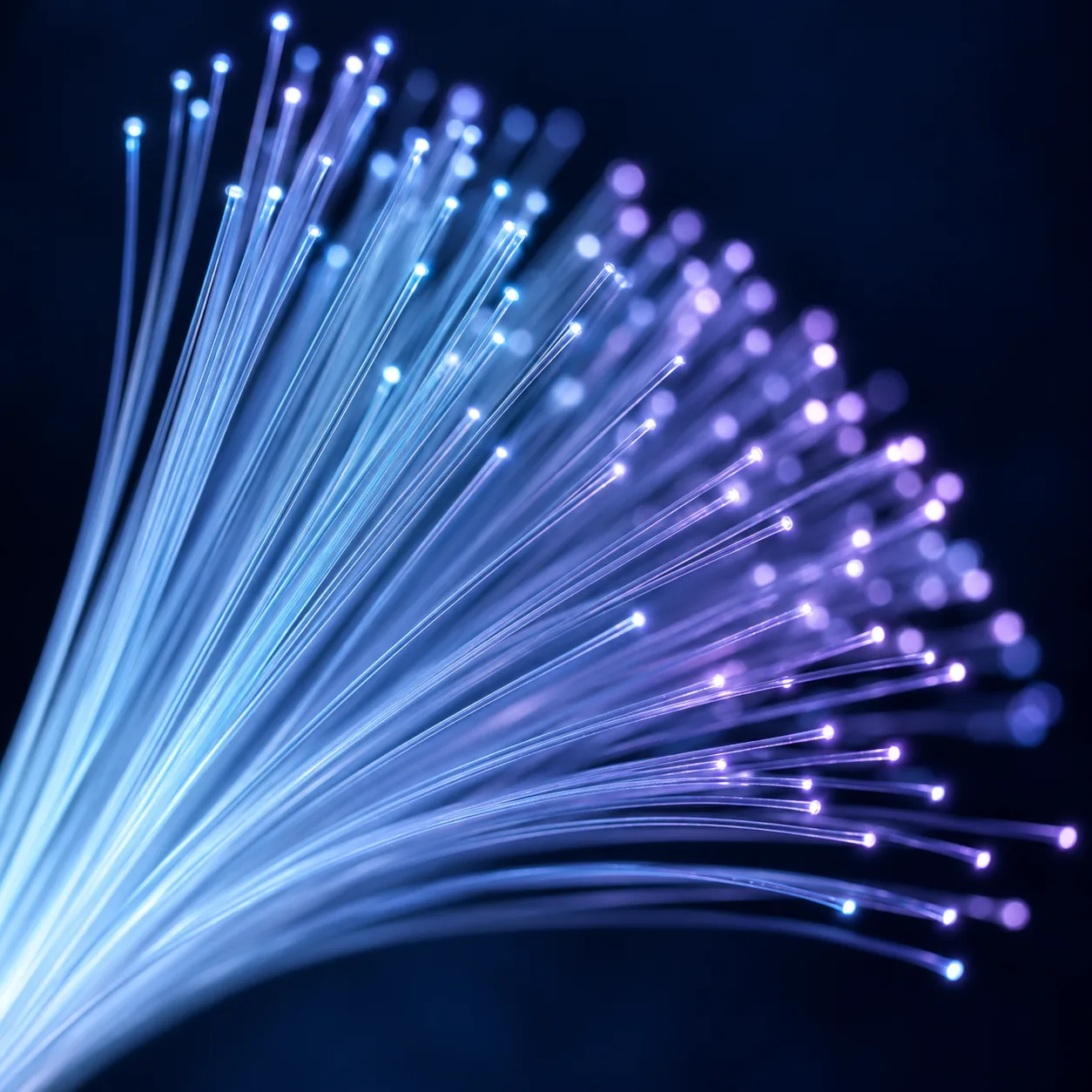A fan of glowing blue and violet fibre-optic strands