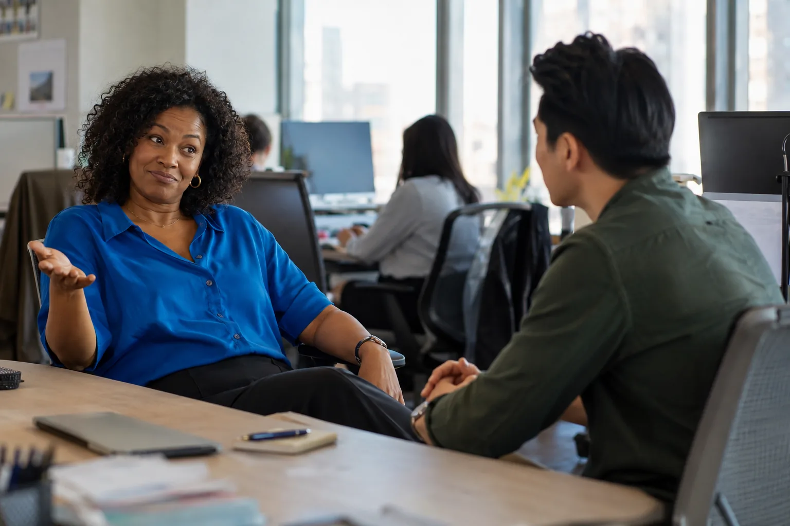 A marketing manager leans back and tells a rep what happened last time